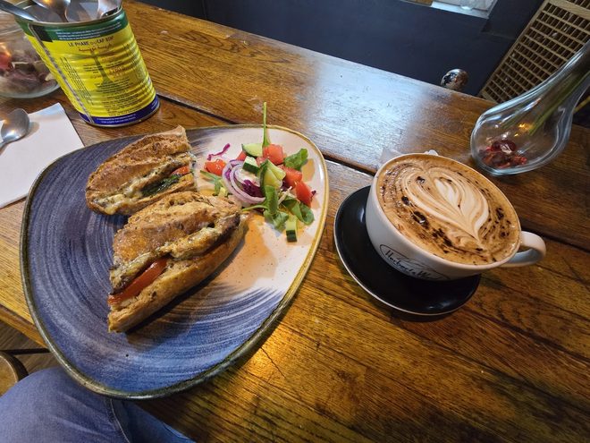 Panini and coffee on a wooden table in the café