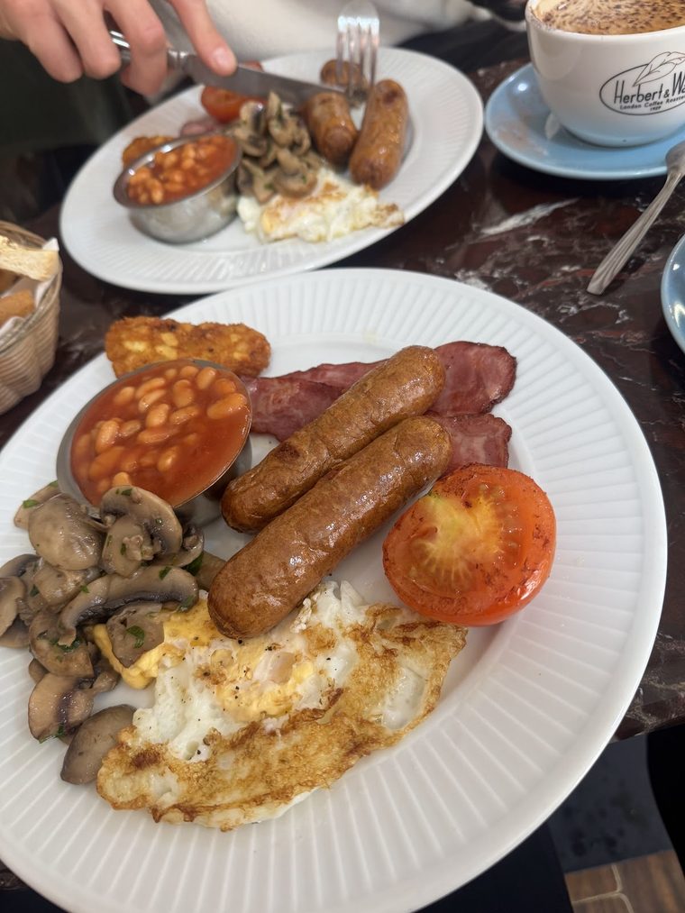 A full English breakfast with sausages, bacon, fried egg, beans, mushrooms and grilled tomato